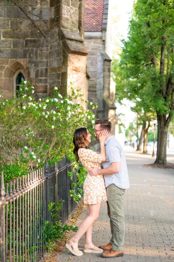 Engagement photograph, beautiful young couple embracing in downtown Raleigh, North Carolina