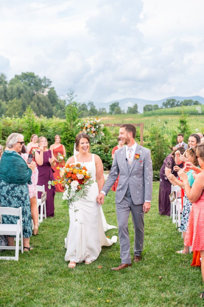 Husband and wife walking back down the aisle after their wedding ceremony